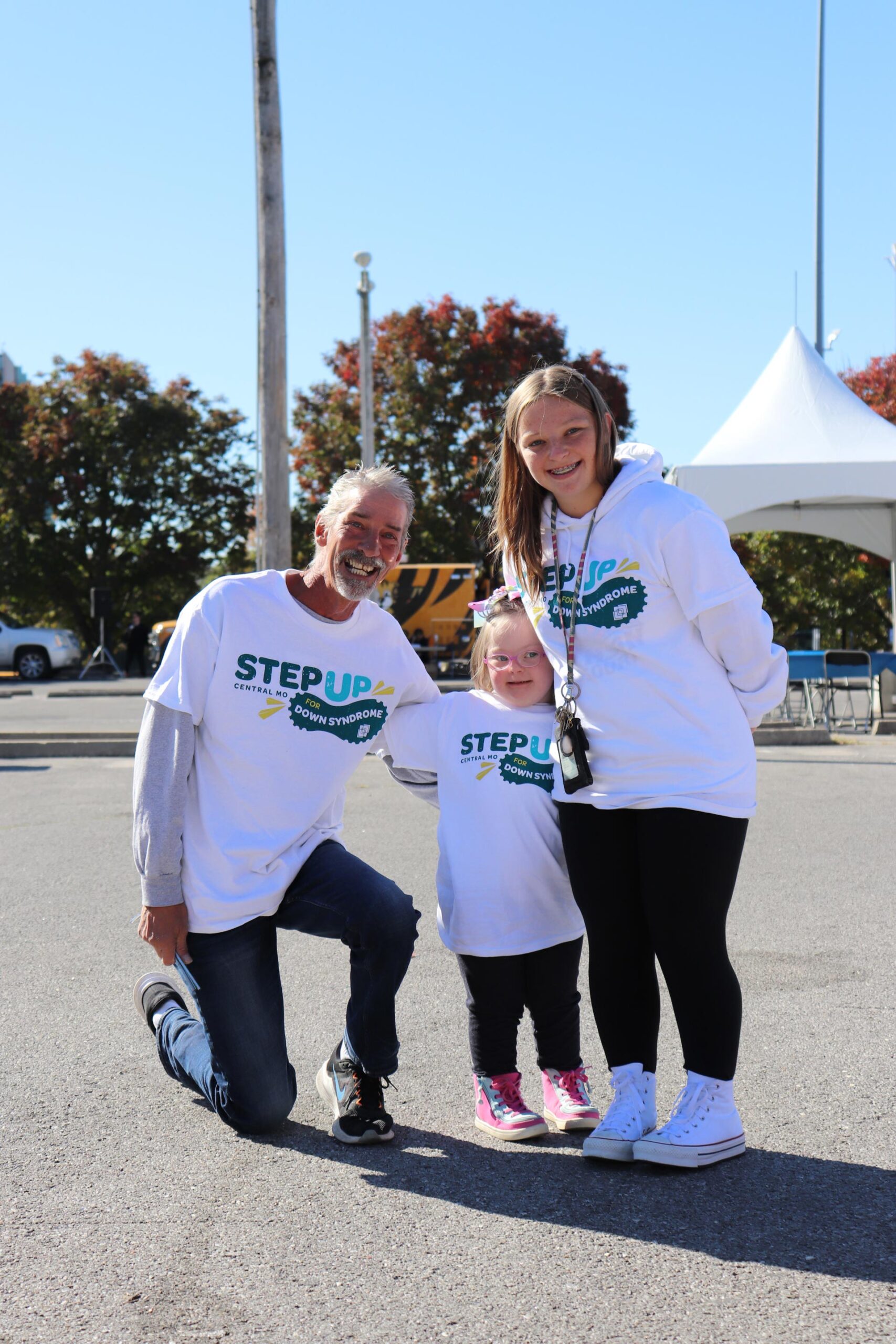 Team Smiling Father Kneeling On Pavement